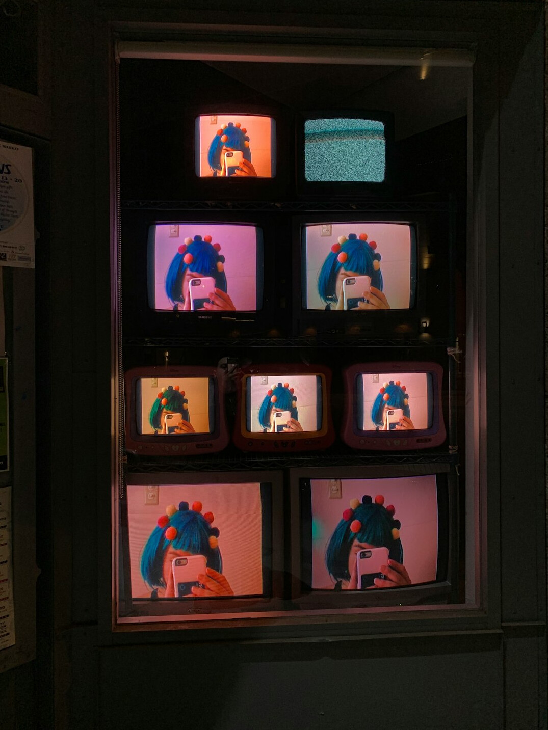 Row of broadcast monitors displaying live camera feeds